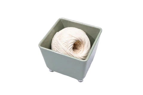 Small sage green organizing tray holding a spool of natural twine for tidy storage and home improvement use