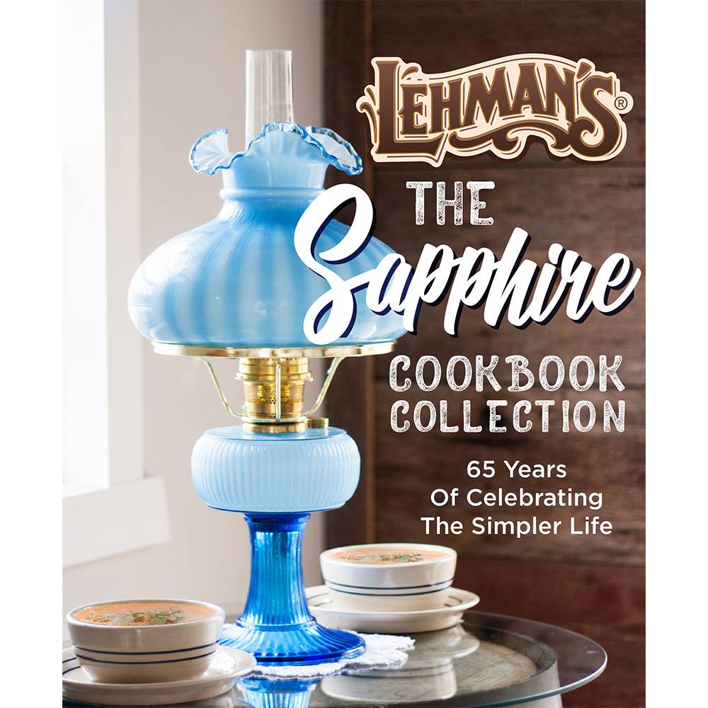 Vintage blue glass oil lamp beside ceramic bowls on a table in a Cooking and Books collection under $50