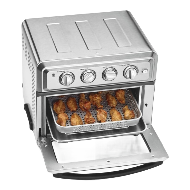 Stainless steel countertop air fryer oven with control knobs and perforated basket holding cooked chicken wings