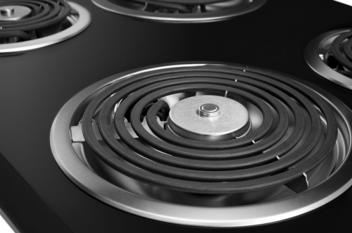Close-up of black electric cooktop coil element with brushed metal center, part of cooktops and kitchen appliances collections