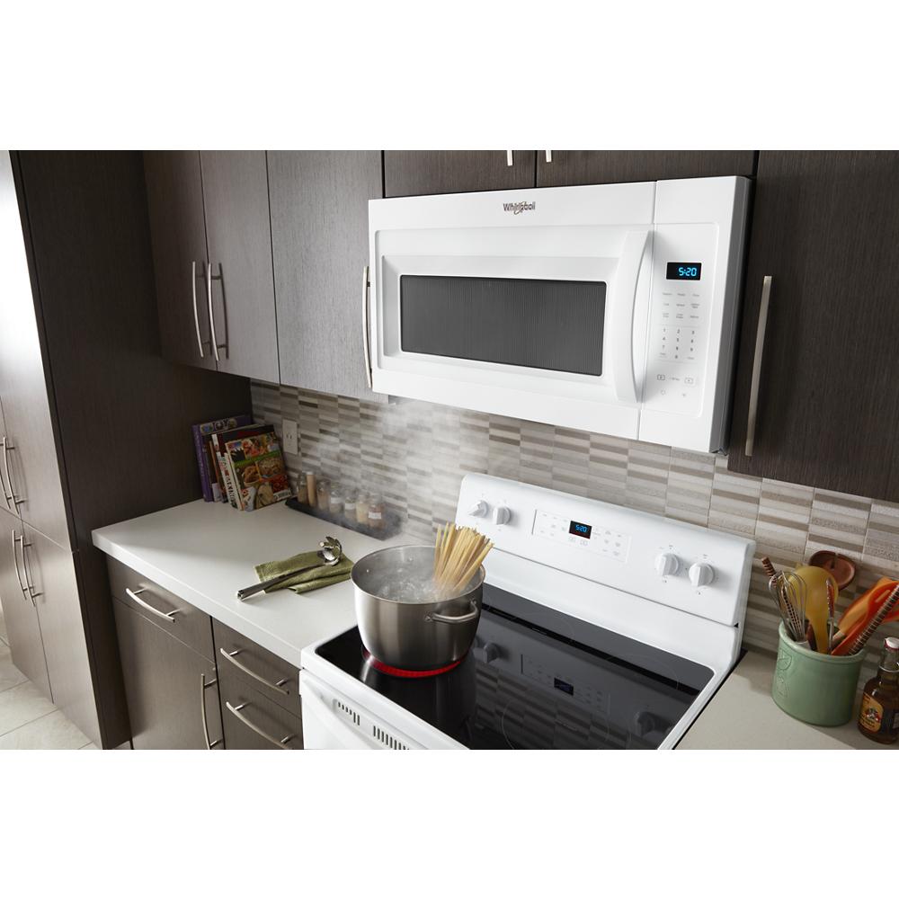 White over-the-range microwave with electronic touch controls installed above electric stove in modern kitchen setting