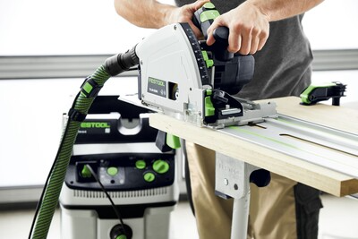 Person using Festool plunge cut track saw with guide rail for precise cuts in Festool power tools collection