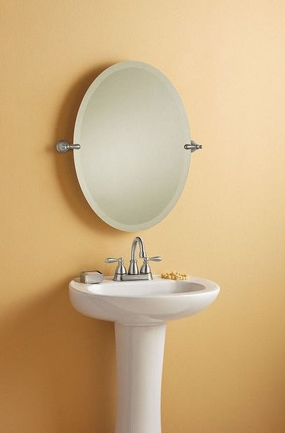 Bathroom pedestal sink with brushed nickel two-handle high-arc faucet and oval wall mirror for home improvement use