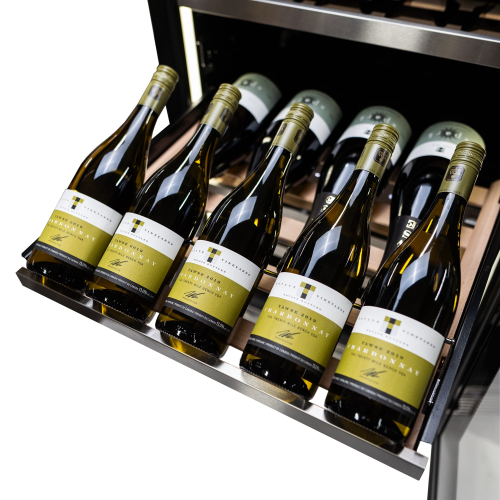 Wine bottles stored horizontally on wooden racks inside a stainless steel under counter wine cellar in Appliances collection