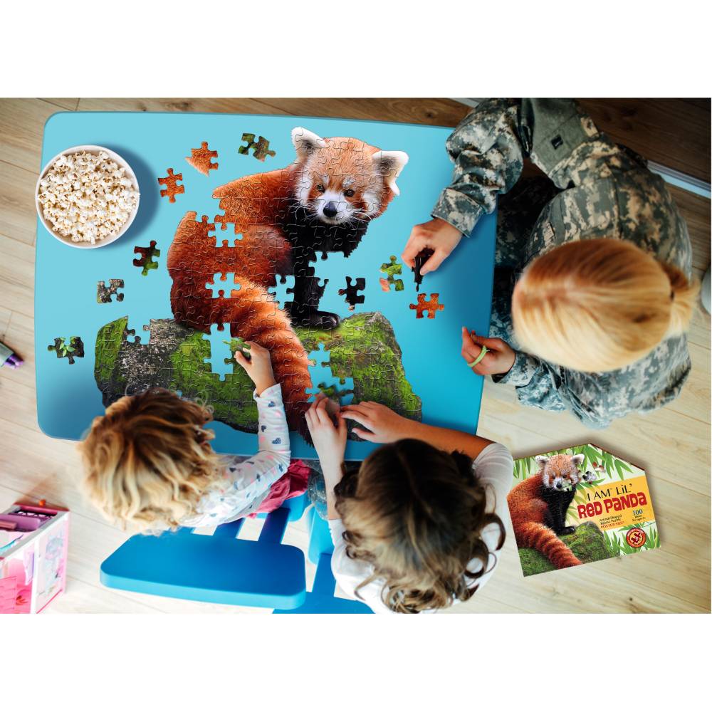 Children and adult assembling a red panda shaped 100-piece jigsaw puzzle on blue table from Toys & Games collection