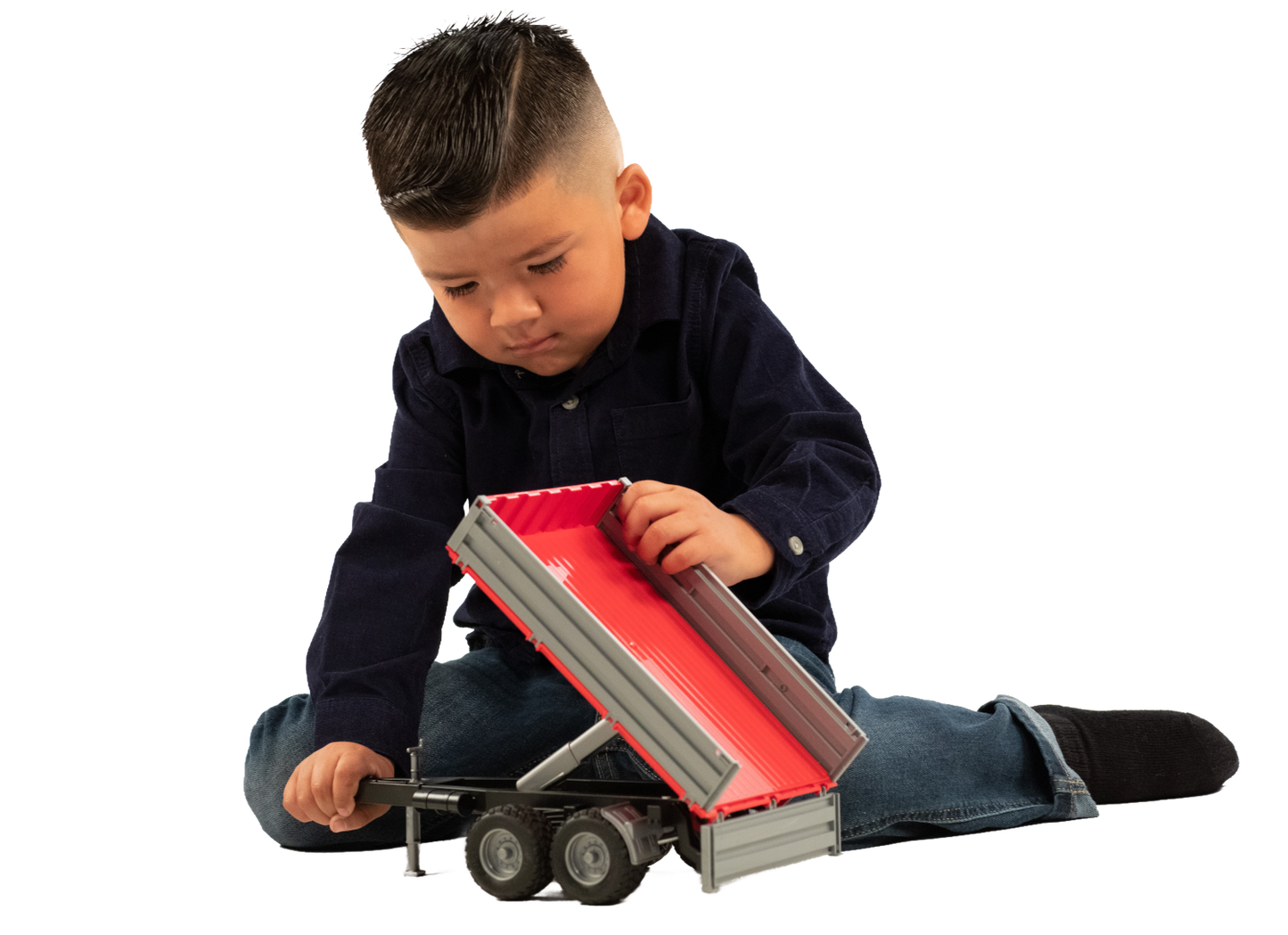 Child playing with small Bruder tipping trailer toy featuring grey sides and red interior in Vehicles & Remote Controlled Toys collection