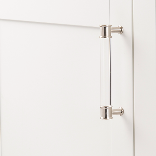 Acrylic and satin nickel midway pull handle installed on a white cabinet door for home improvement projects