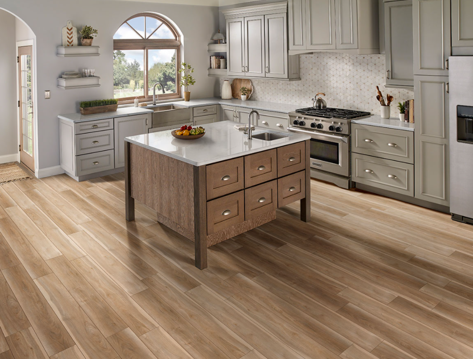 Bright blonde luxury vinyl plank flooring with natural wood texture in modern kitchen setting under $100 flooring collection