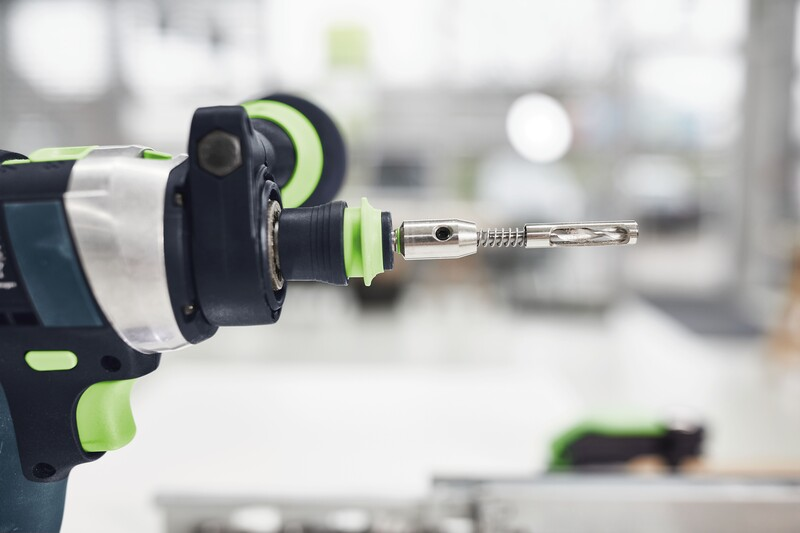 Close-up of a Festool Centrotec 5mm self-centering bit attached to a drill in a home improvement setting