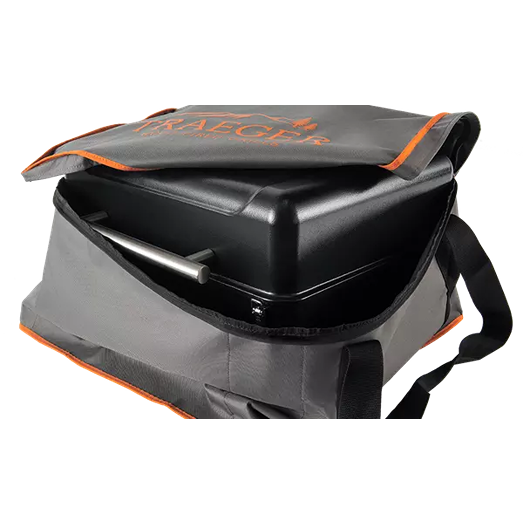 Gray fabric carrying bag with orange trim and handles partially opened to reveal a black portable grill inside