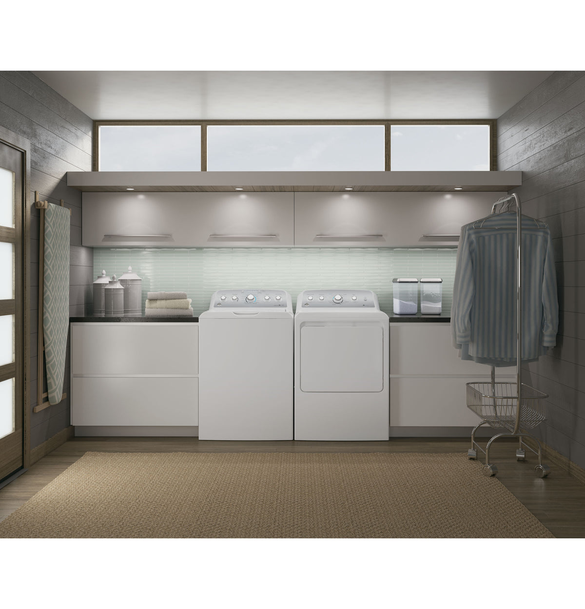 Laundry room with white top-load washer and electric dryer, modern cabinetry, and natural light from high windows