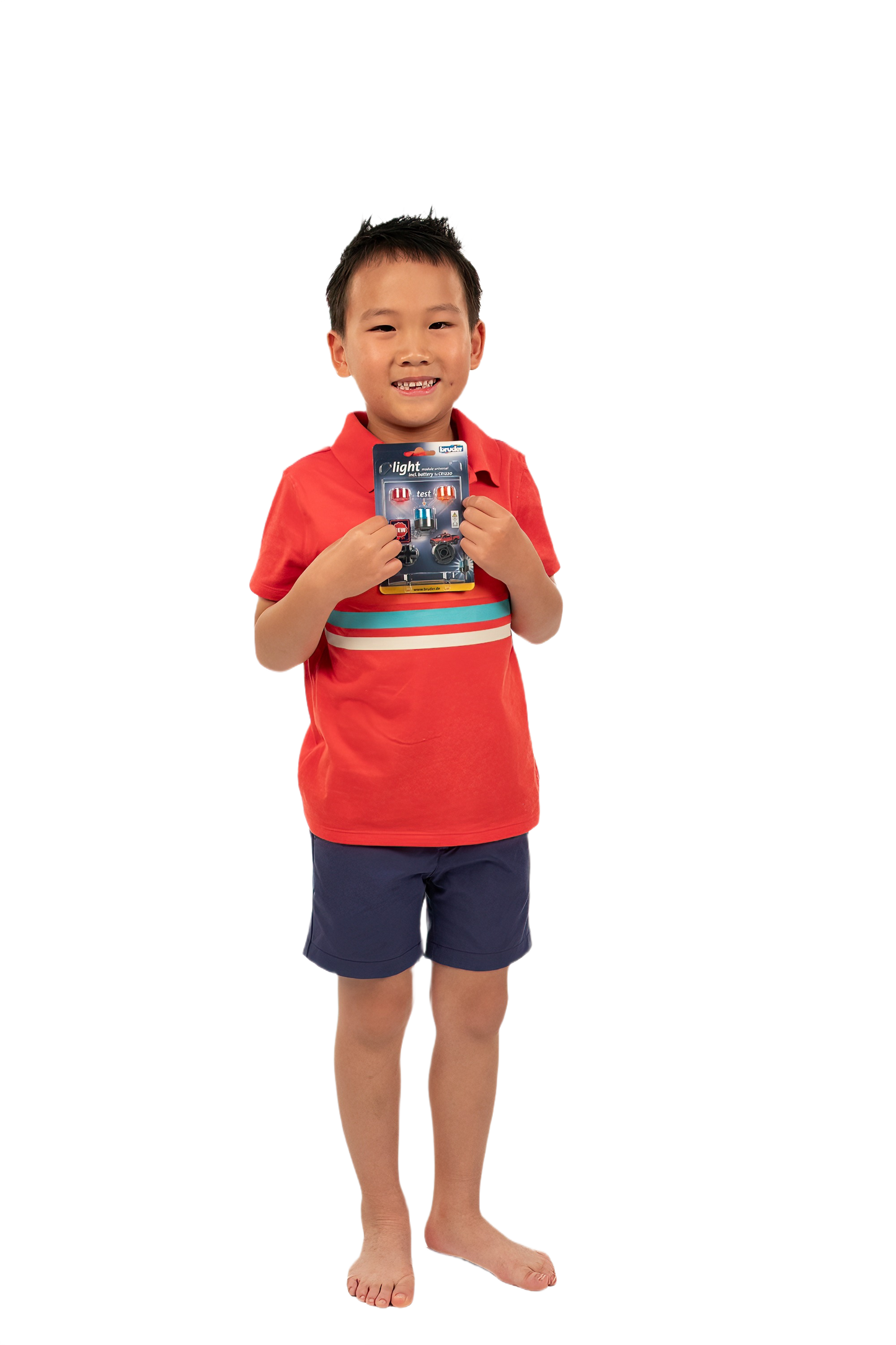 Young boy in red shirt and blue shorts holding Bruder rotating beacon light packaging from Toys & Games collection