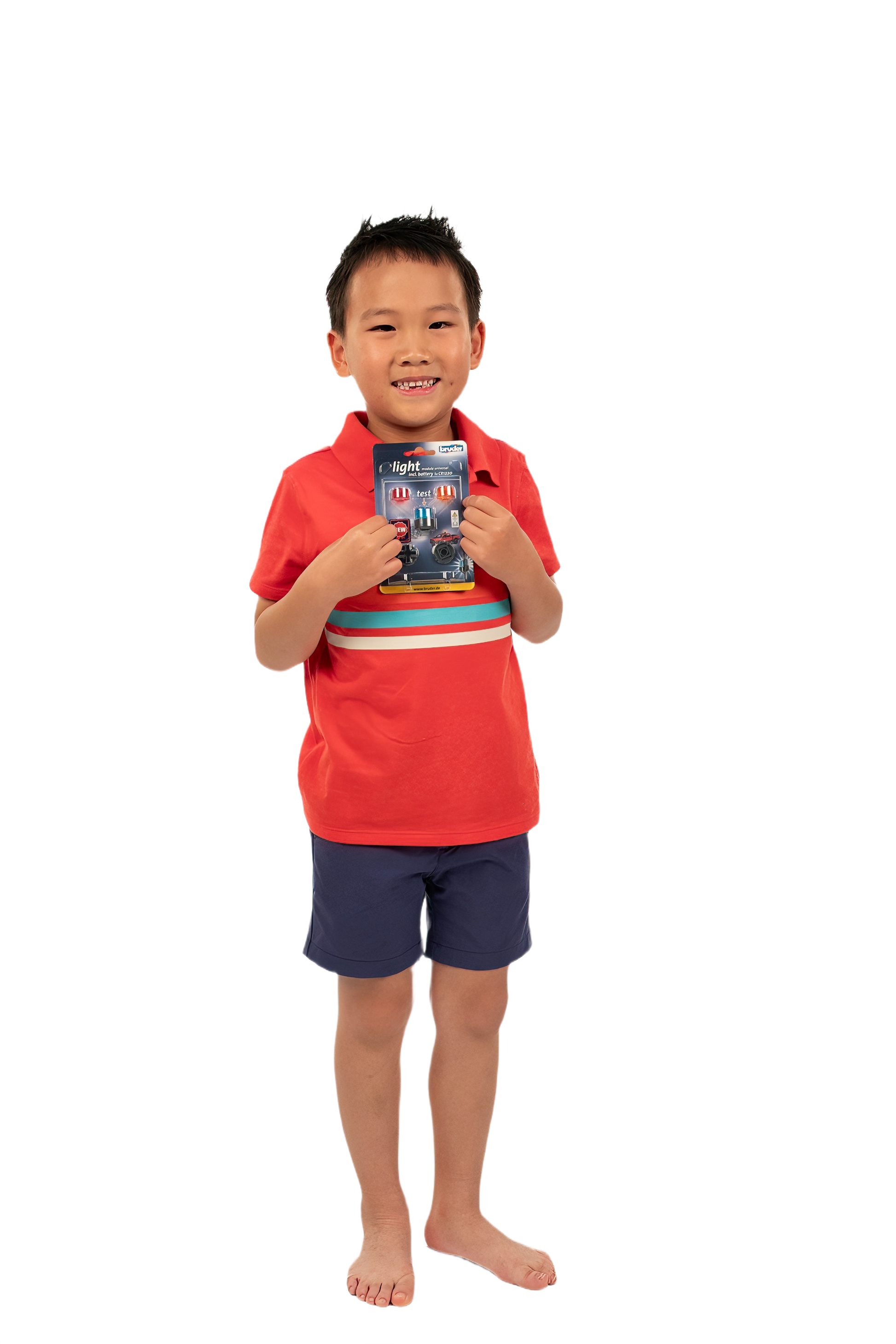 Young boy in red shirt and blue shorts holding Bruder rotating beacon light packaging from Toys & Games collection