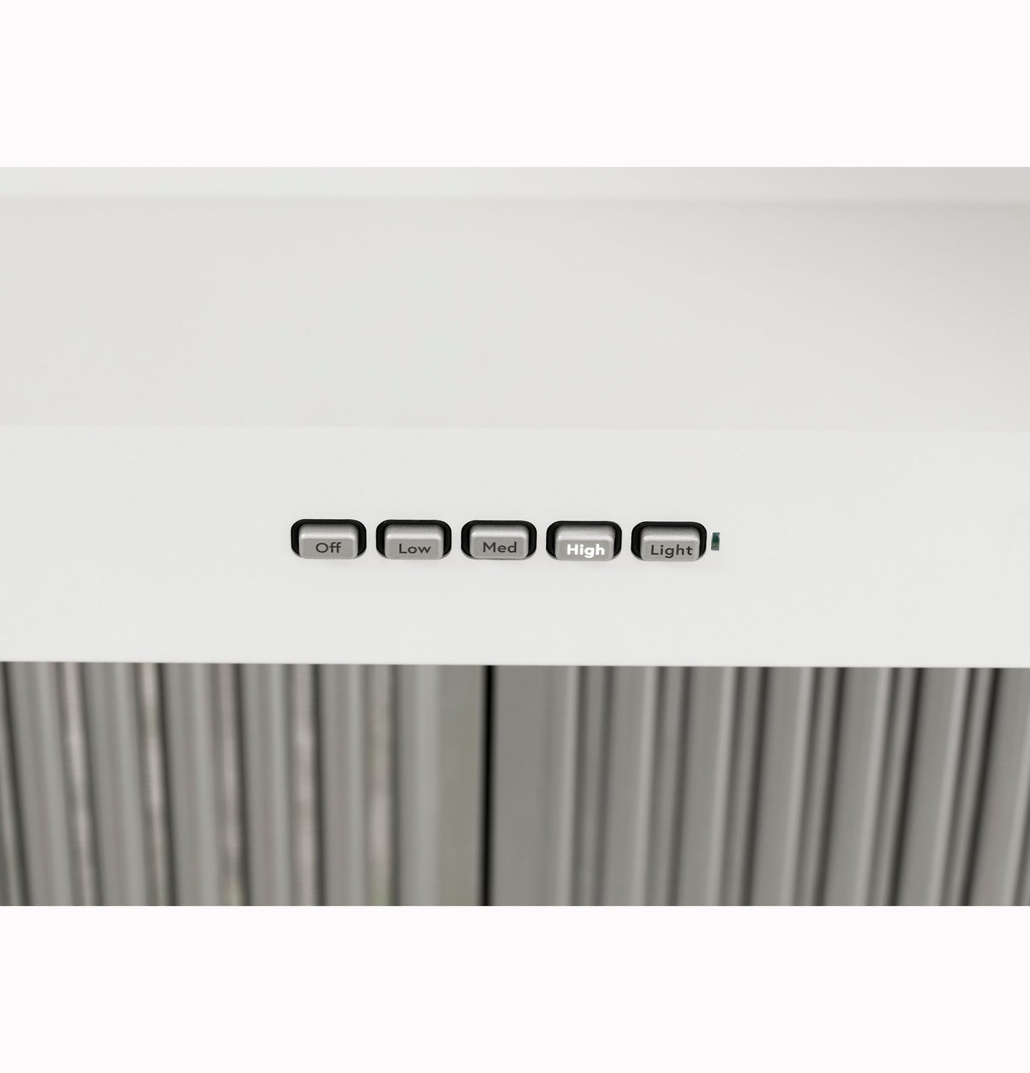 Close-up of white commercial range hood control panel with buttons for fan speed and light in kitchen appliances setting