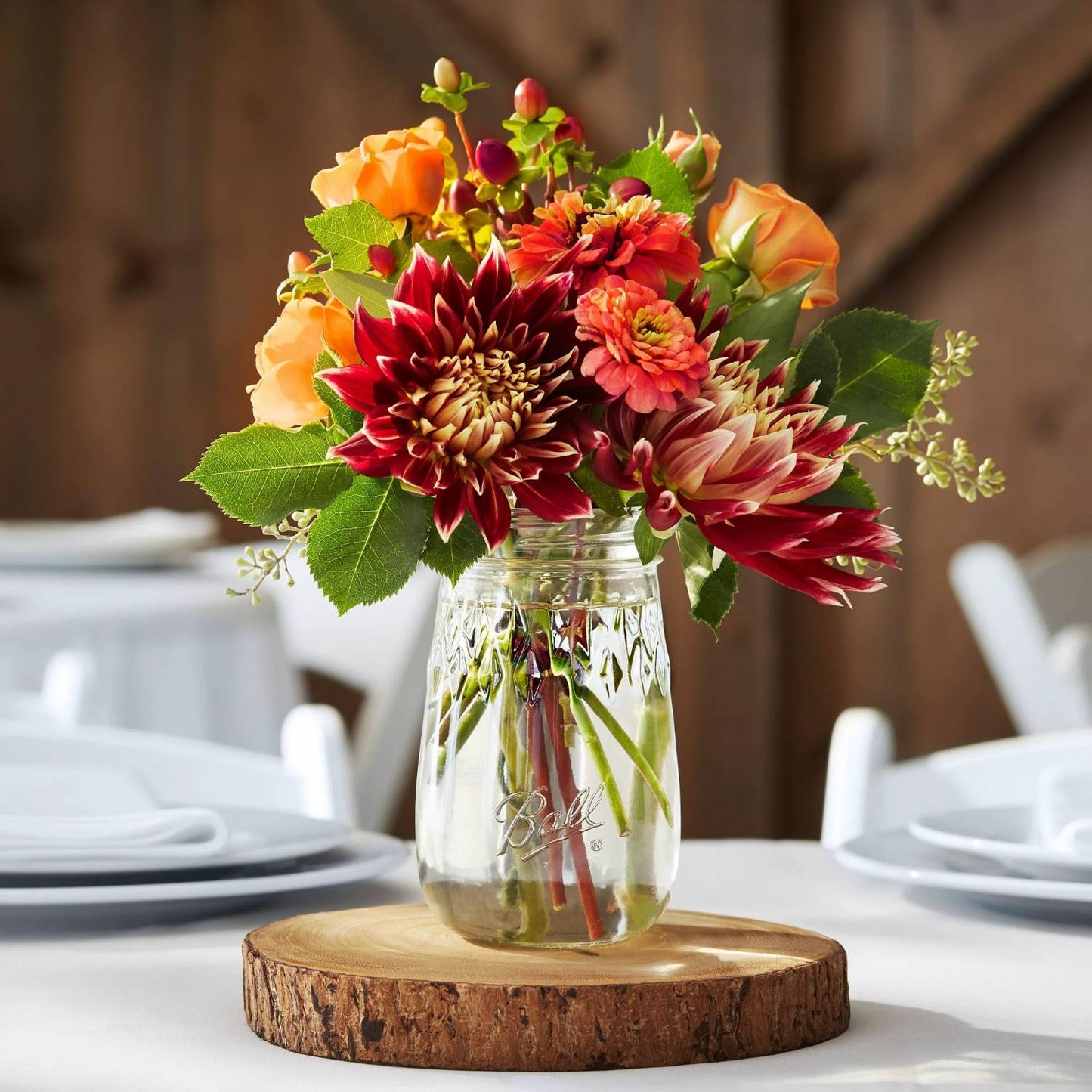 Clear Ball pint canning jar with floral bouquet on rustic wood slice in kitchenware and Under $50 collections