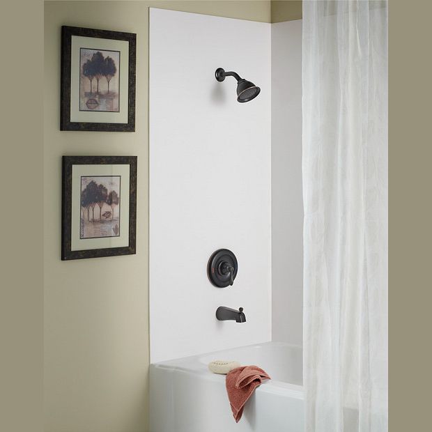 Mediterranean bronze showerhead, handle, and tub spout set installed in a bathroom with neutral decor elements
