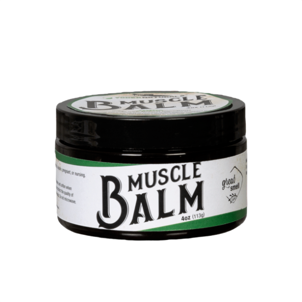 Jar of muscle balm with black lid and white label featuring bold black lettering and green accent stripe