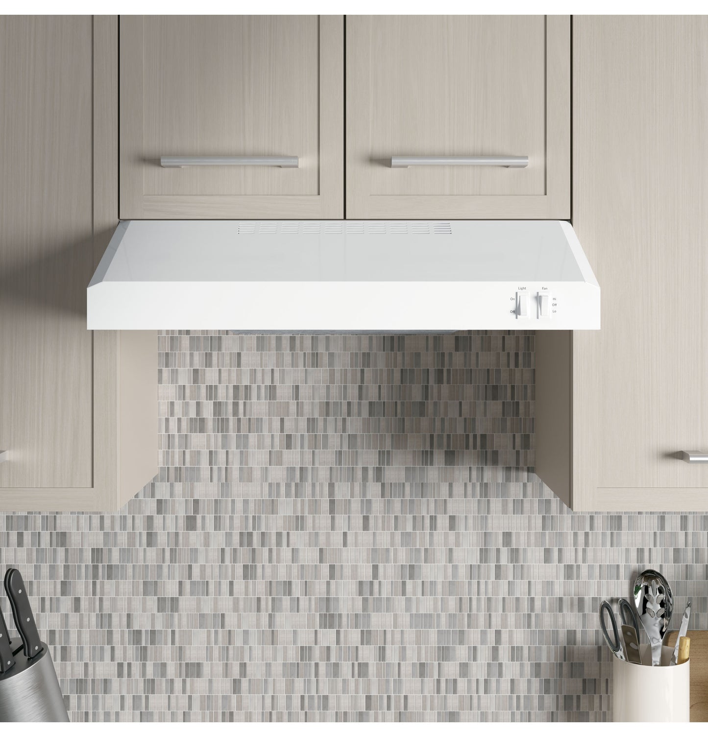 White under-cabinet range hood with control knobs installed above mosaic tile backsplash from Range Hoods and Kitchen & Kitchenware collections