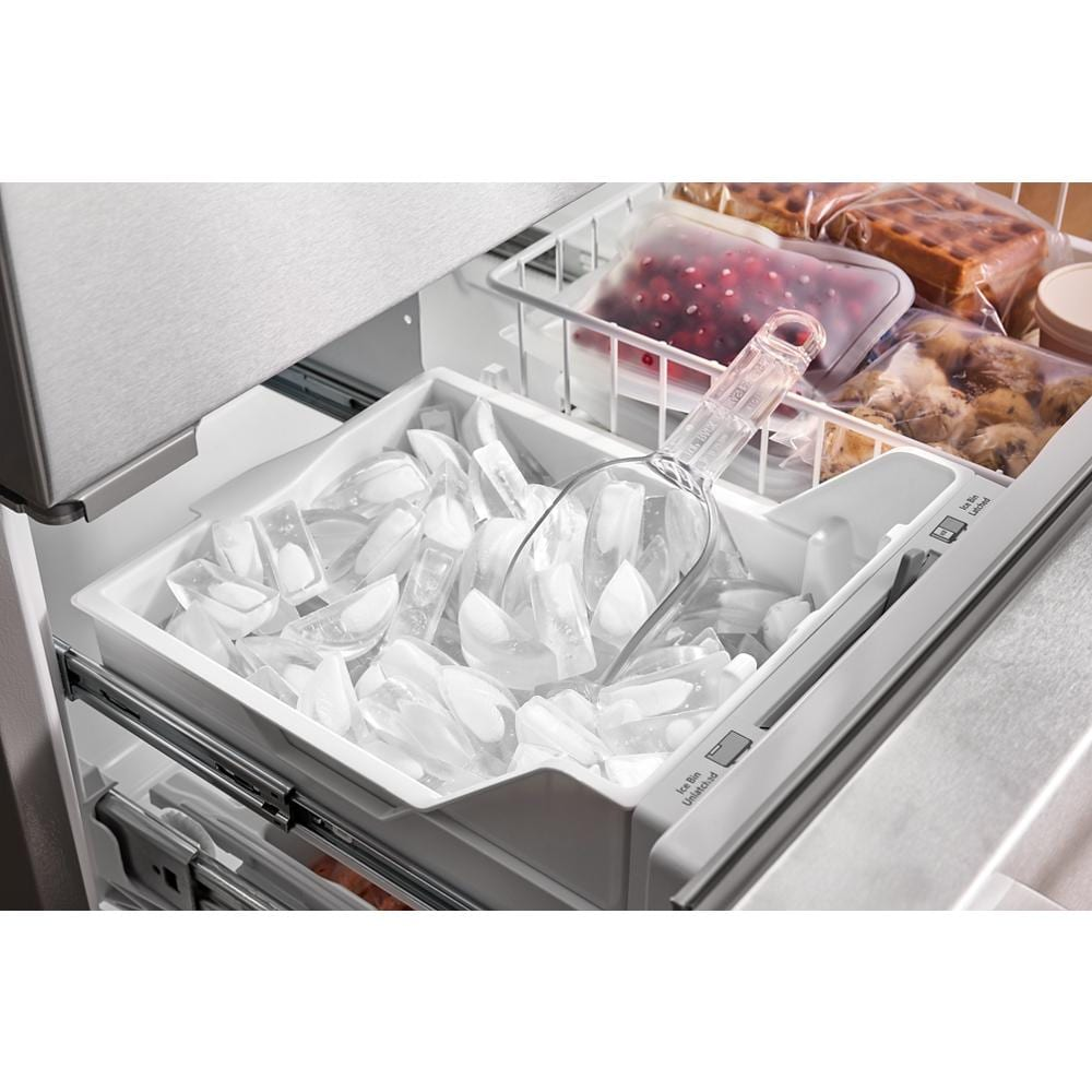 Bottom freezer drawer with clear plastic ice bin and scoop inside stainless steel French door refrigerator drawer