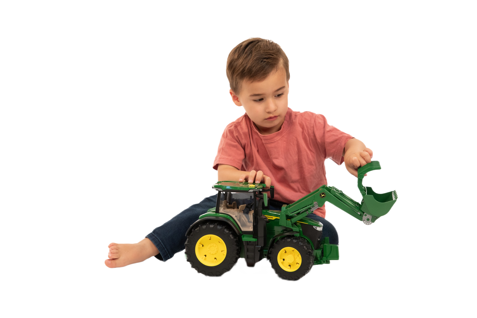 Child playing with green Bruder John Deere 7R 350 toy tractor featuring movable front loader for home improvement play