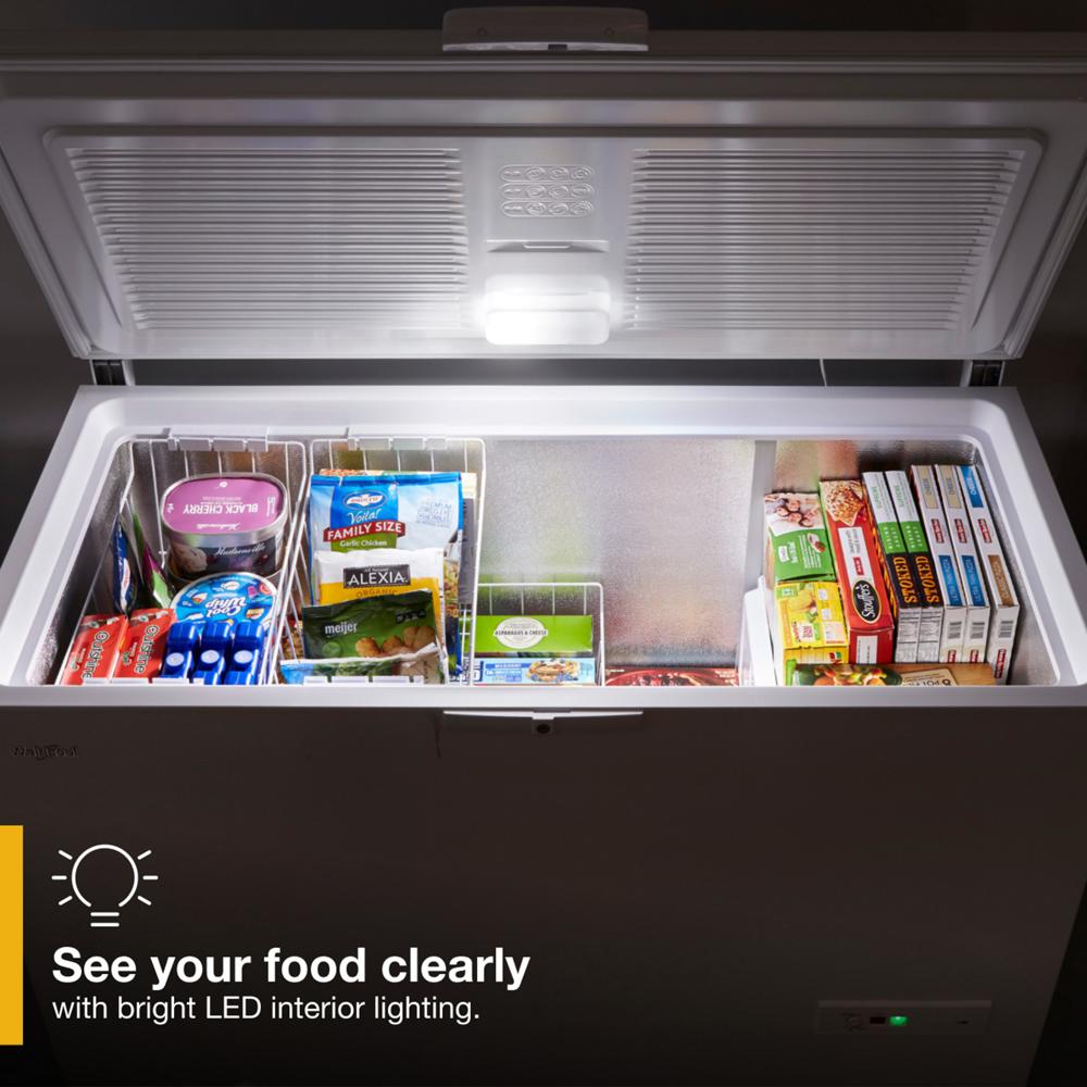 Open chest freezer with organized frozen food and bright LED interior light from Freezers & Ice Makers collection