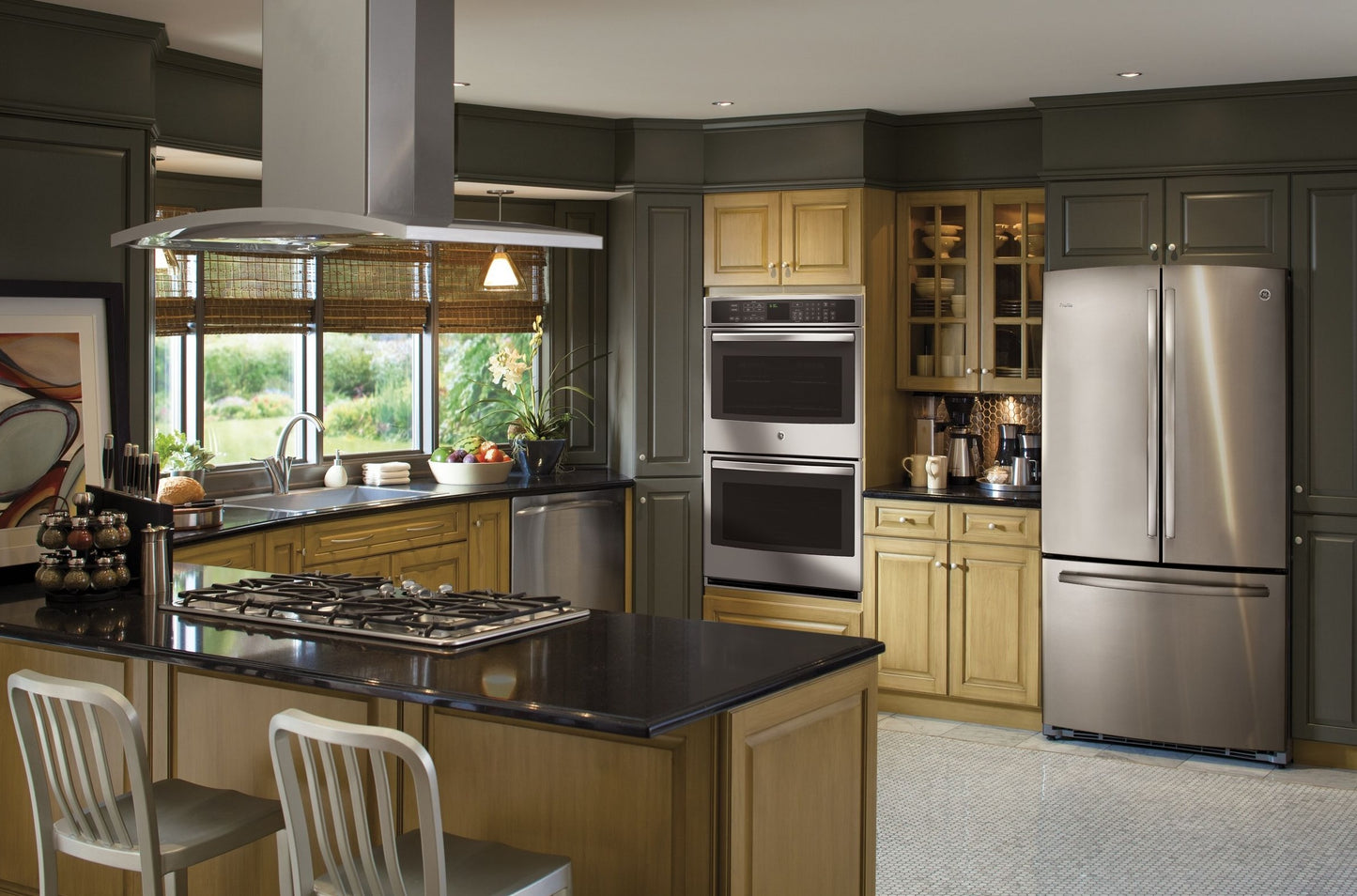 Modern kitchen with 36" island-mount chimney hood above cooktop in open kitchen featuring stainless steel appliances