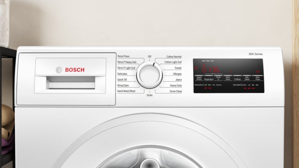 Compact Bosch front load washer with control dial, digital display, and cycle options for efficient laundry care