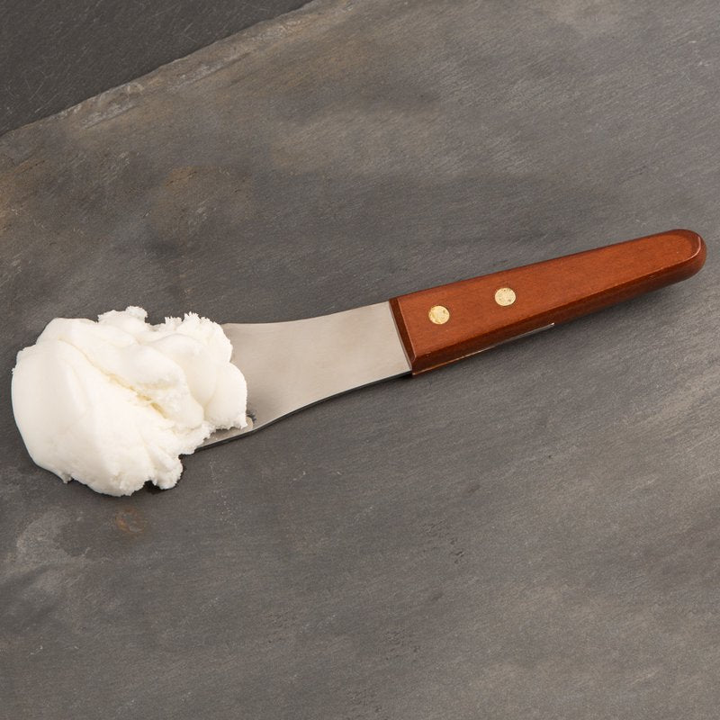 Stainless steel spade with hardwood handle holding a scoop of white ice cream on dark surface from kitchen utensils collection