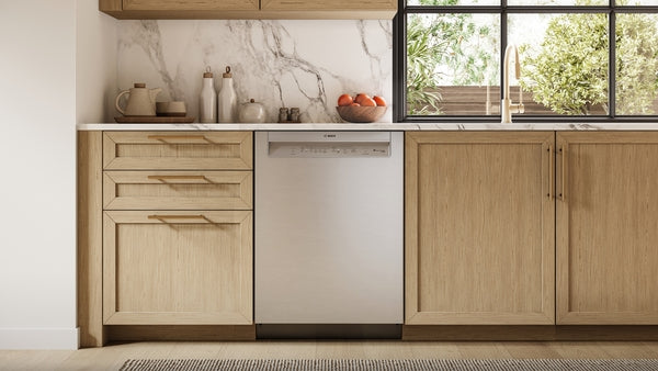 Built-in 24-inch stainless steel anti-fingerprint dishwasher integrated into modern kitchen with natural wood cabinets and marble backsplash