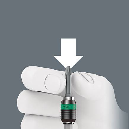 Hand tool bit with quick-release chuck held by gloved hand for woodworking and home improvement tasks