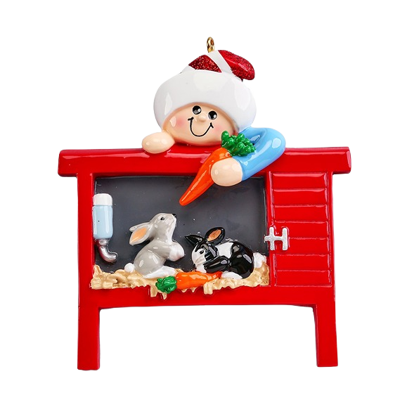 Cheerful child in Santa hat feeding two rabbits inside red cage from Christmas Ornaments & Tree Decorations collection