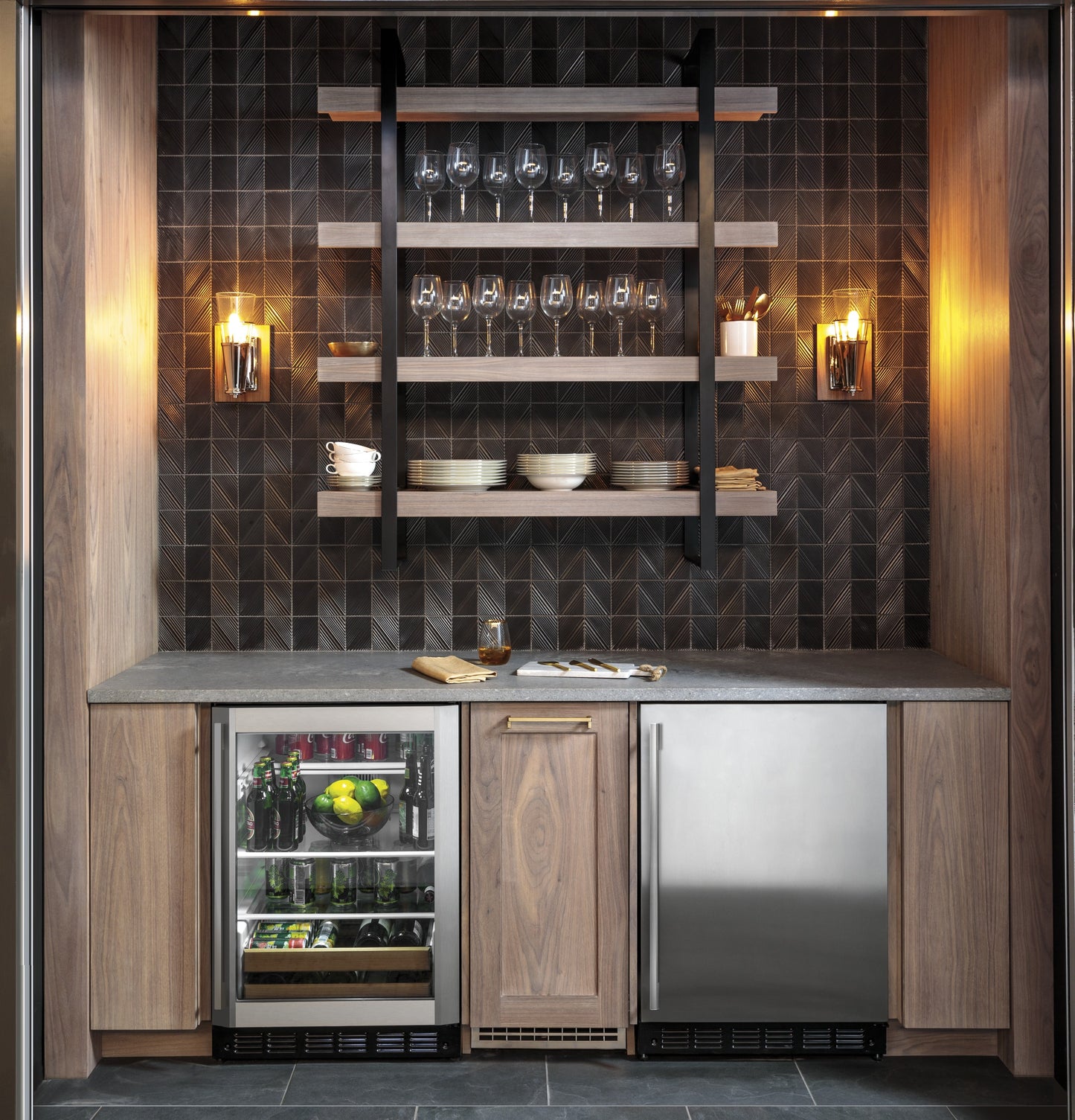 Built-in beverage refrigerator with glass door alongside stainless steel bar refrigerator in modern kitchen setting