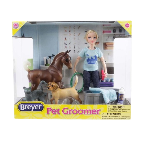 Blonde doll in blue grooming shirt with horse, dog, cat figures, towel, shampoo, hose, and grooming brush set