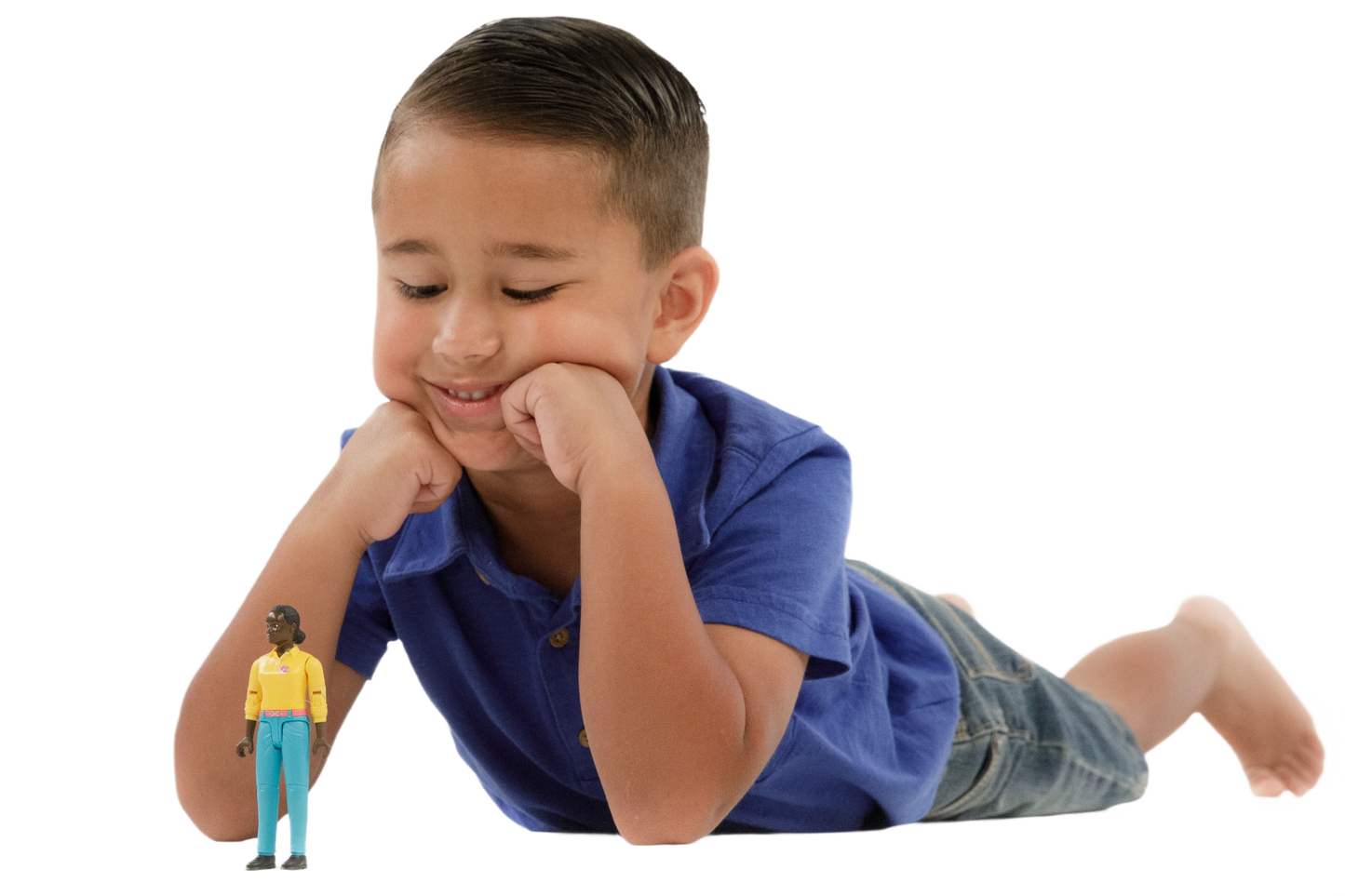 Young boy lying on floor playing with Bruder Toys woman action figure in turquoise jeans and yellow top from Toys & Games collection