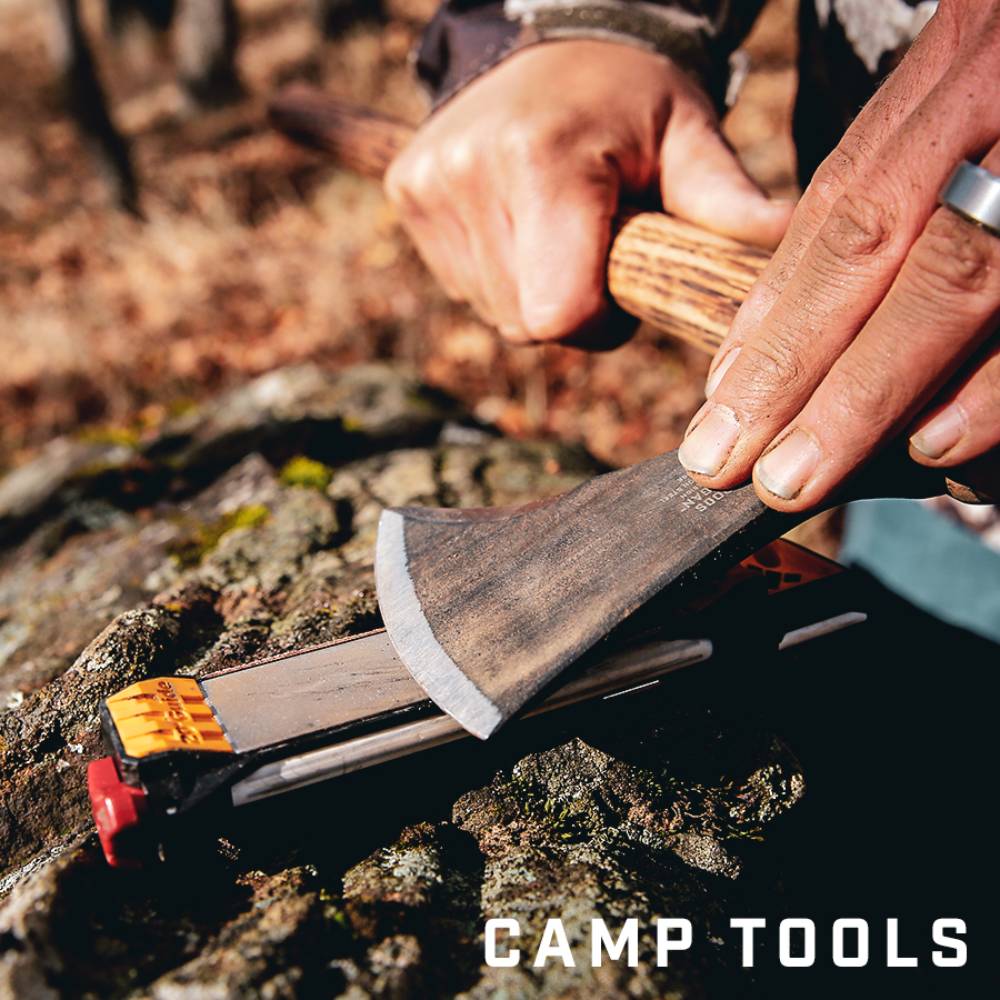 Hands sharpening a small axe blade on a versatile guided sharpener for woodworking and outdoor tools under $100 collections