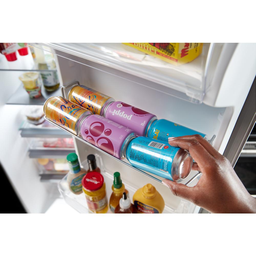 Hand placing a canned beverage in gallon door bin of side-by-side refrigerator in Kitchen & Kitchenware collection
