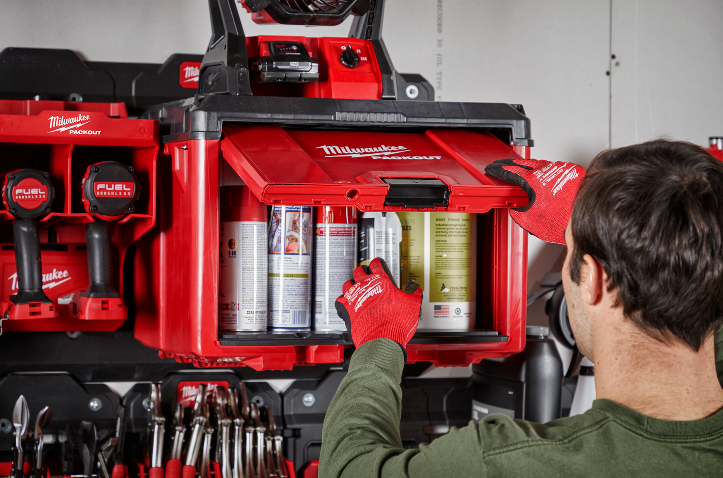 Red Milwaukee PACKOUT storage cabinet with modular stacking and hanging system for efficient tool and workshop organization