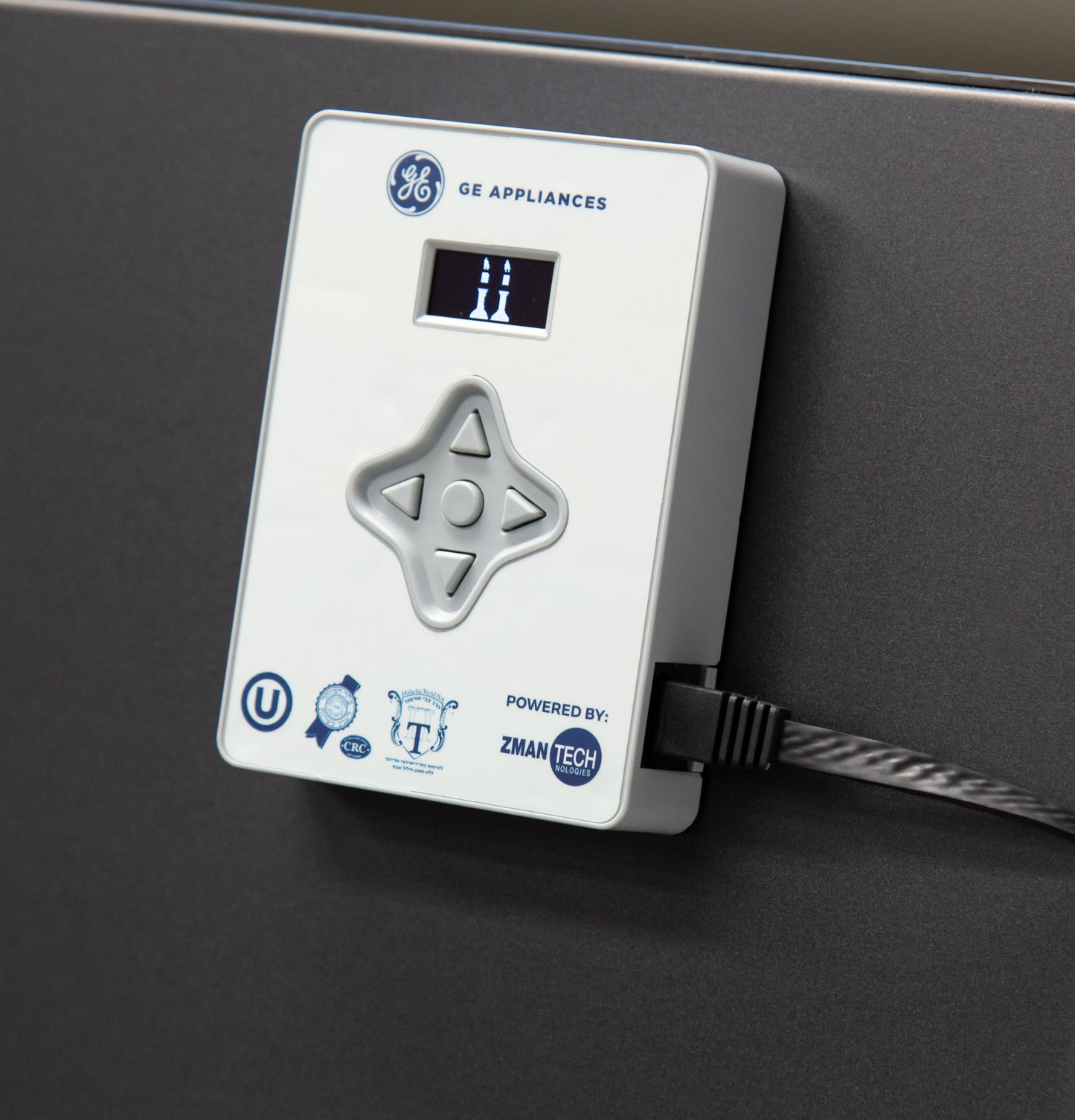 Close-up of white digital control device with navigation buttons and small screen on dark appliance surface from kitchen appliances collection