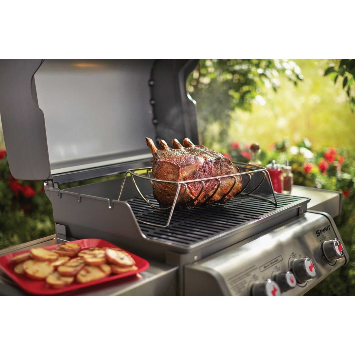 Stainless steel rib rack holding ribs upright on gas grill for even cooking in outdoor living and grill accessories collections