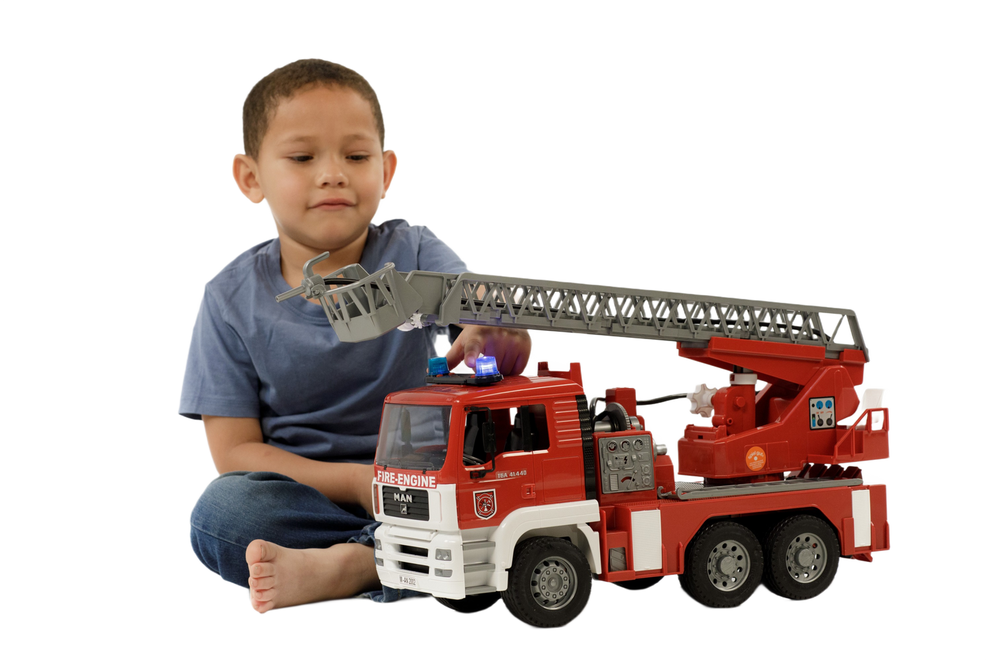 Child playing with detailed red and white Bruder Toys fire engine featuring extendable ladder, water pump, lights, and sounds