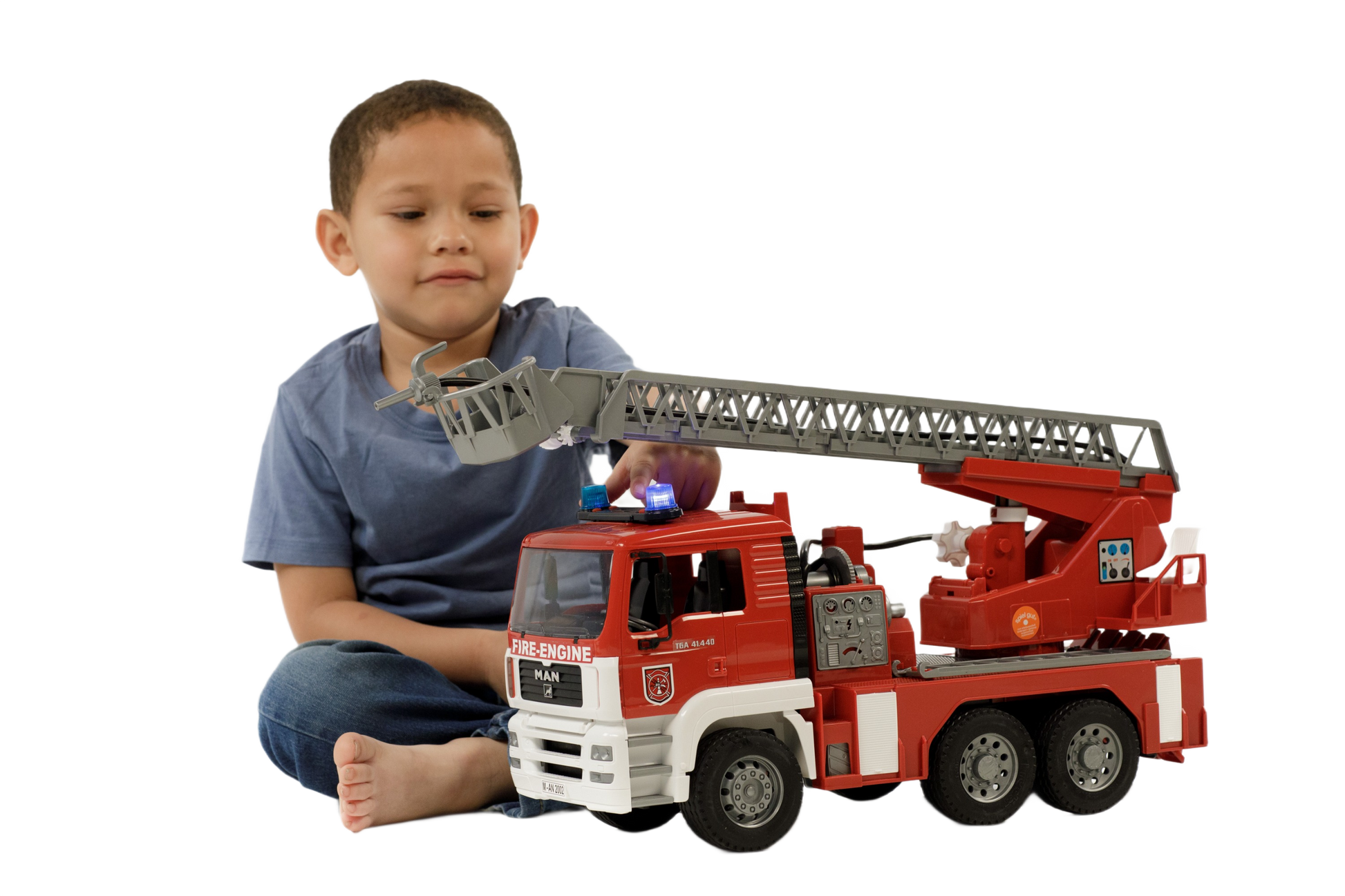 Child playing with detailed red and white Bruder Toys fire engine featuring extendable ladder, water pump, lights, and sounds