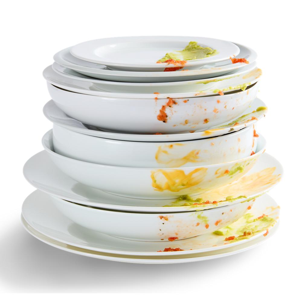 Stack of dirty white plates with food residue in kitchenware collection for home improvement and appliances.
