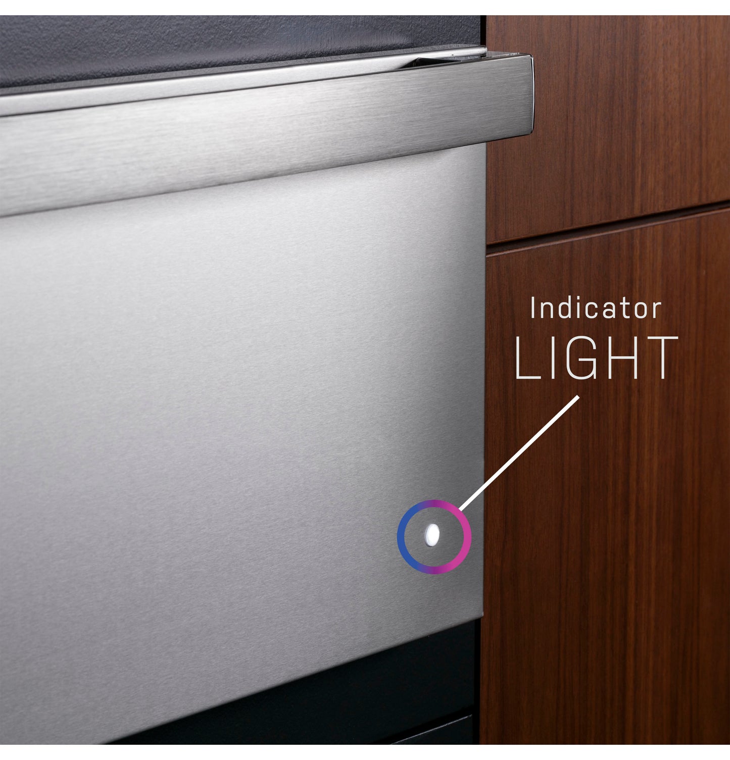 Close-up of stainless steel warming drawer showing illuminated indicator light in modern kitchen cabinetry setting