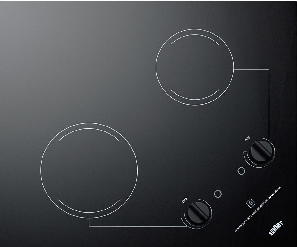 Black ceramic glass electric cooktop with two radiant burners and control knobs in kitchen appliances collection