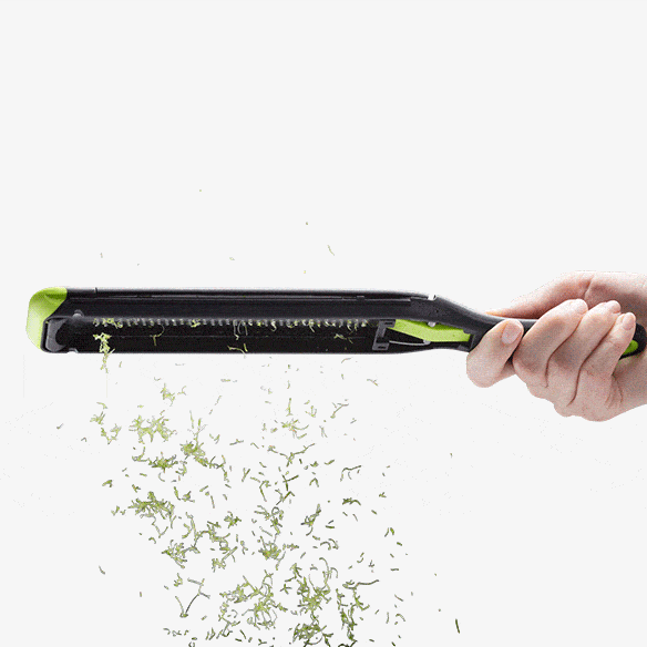 Handheld kitchen zester with stainless steel blades and ergonomic black and green handle for kitchenware and cooking utensils collections