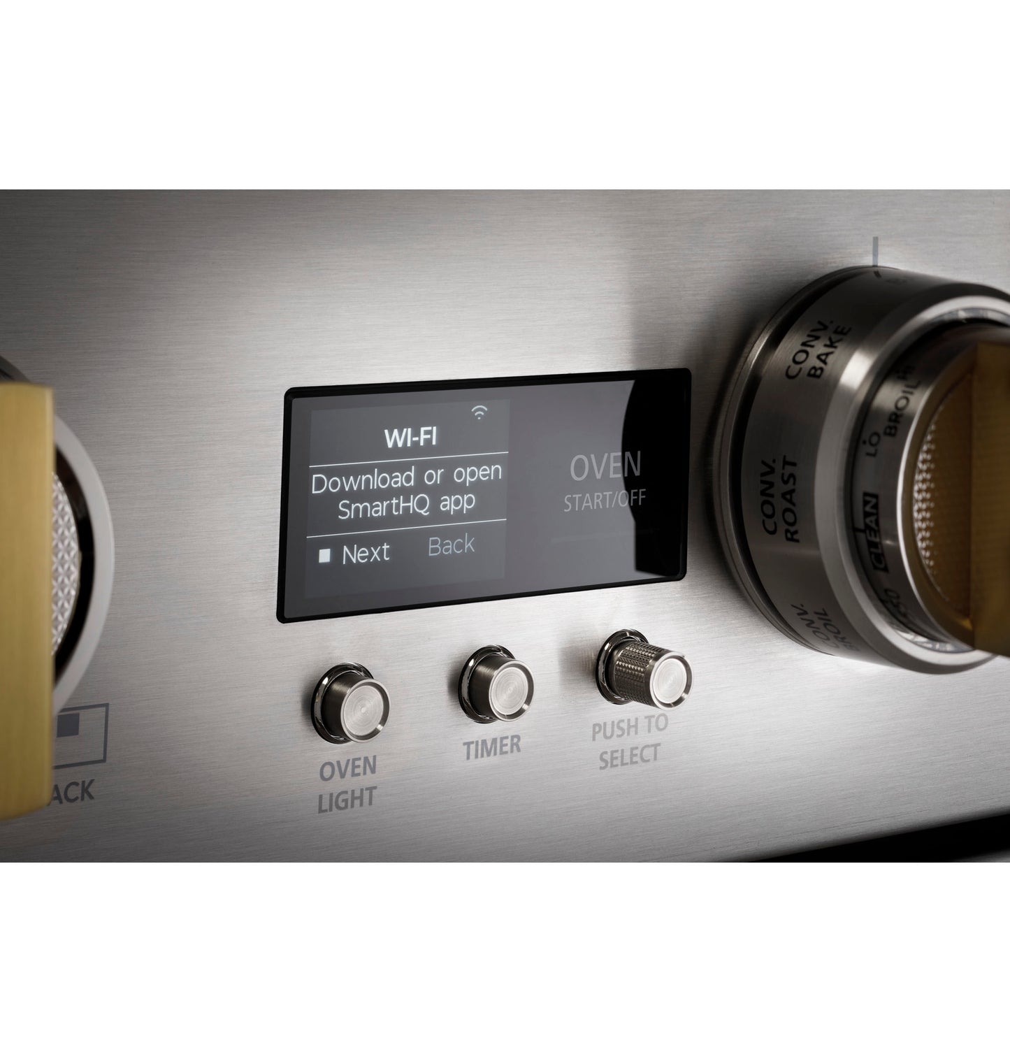 Close-up of stainless steel range control panel showing digital Wi-Fi setup screen and three brushed metal knobs