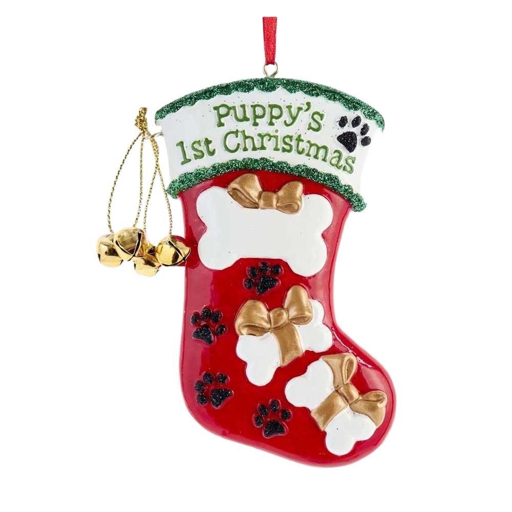 Red Christmas stocking ornament with gold bows, black paw prints, and jingle bells for puppy’s first holiday celebration