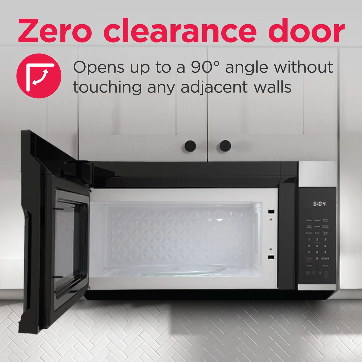 Black over-the-range microwave with door open at 90 degrees showing interior and digital control panel in kitchen setting