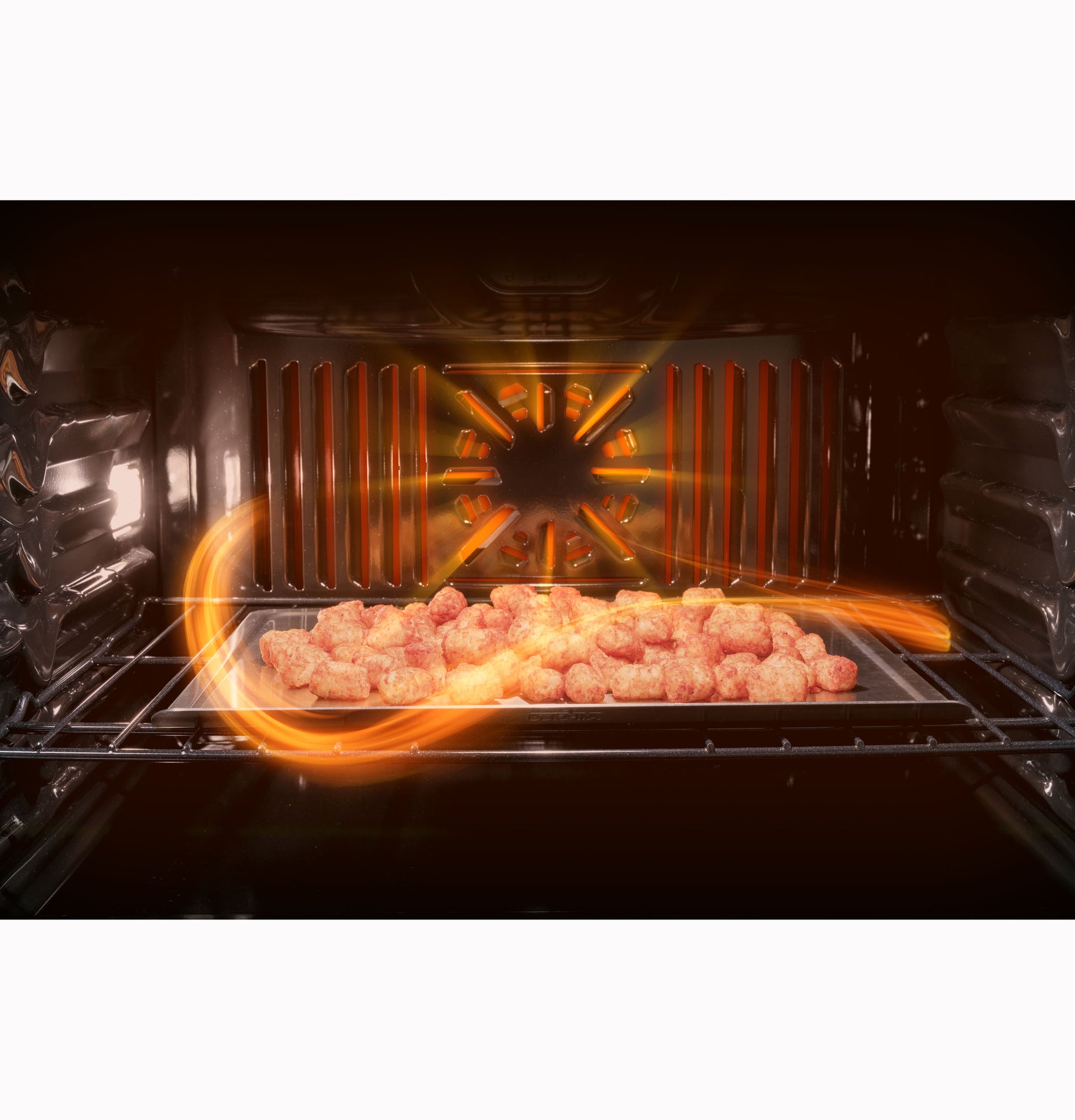 Interior view of convection wall oven with food on a baking sheet and airflow pattern highlighted in orange lines
