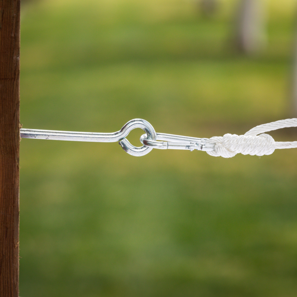 Metal zinc-coated lag screw eye securing white rope to wooden post in hardware, hooks & eyes, and fasteners collections